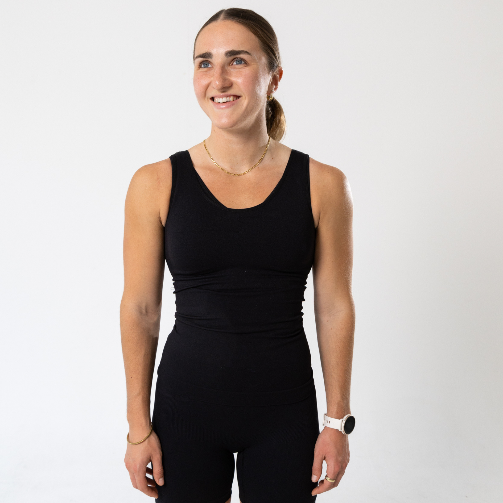 Woman wearing black KORFORM™ compression tank front view
