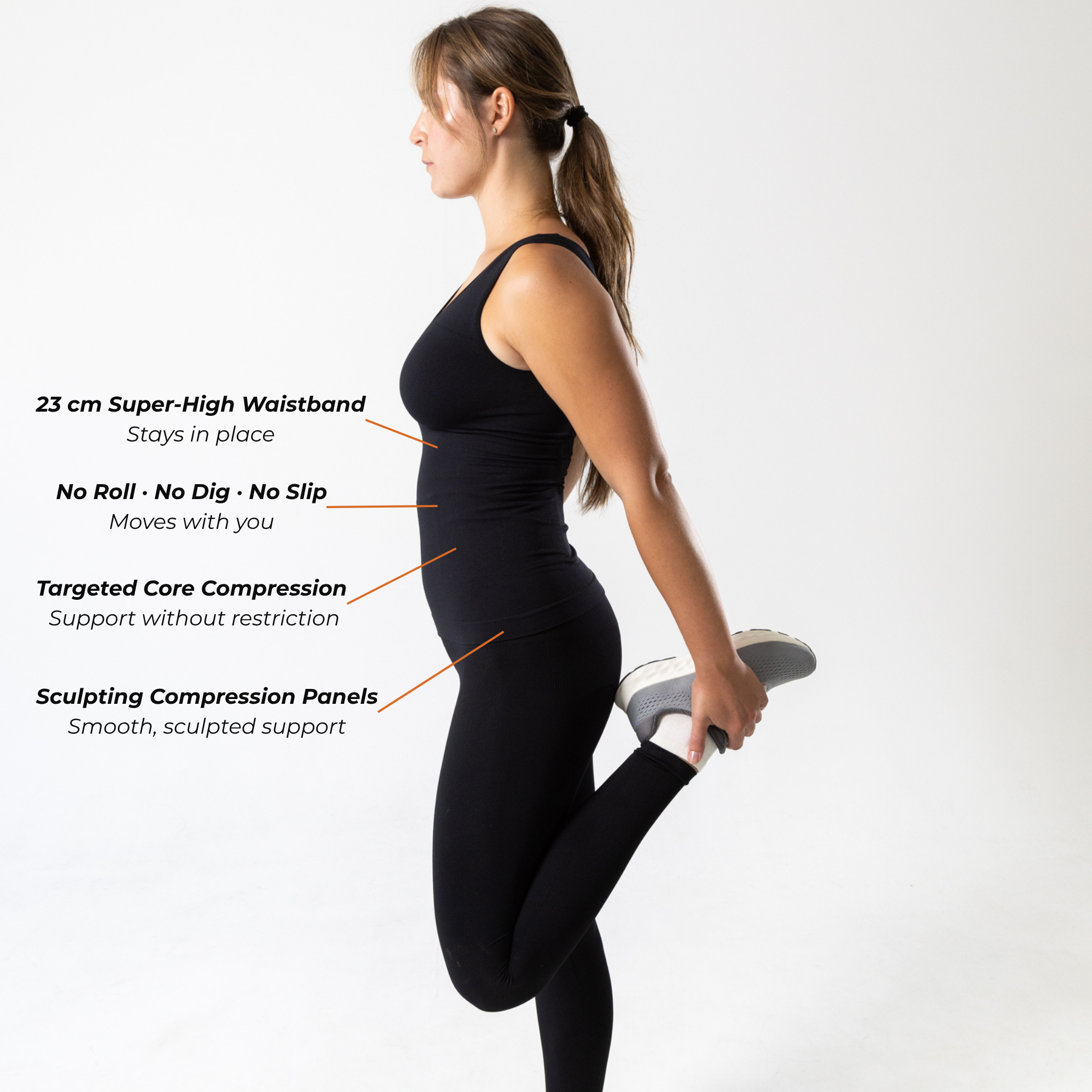 Side view of woman wearing black KORFORM™ high-waisted compression leggings with compression technology highlights