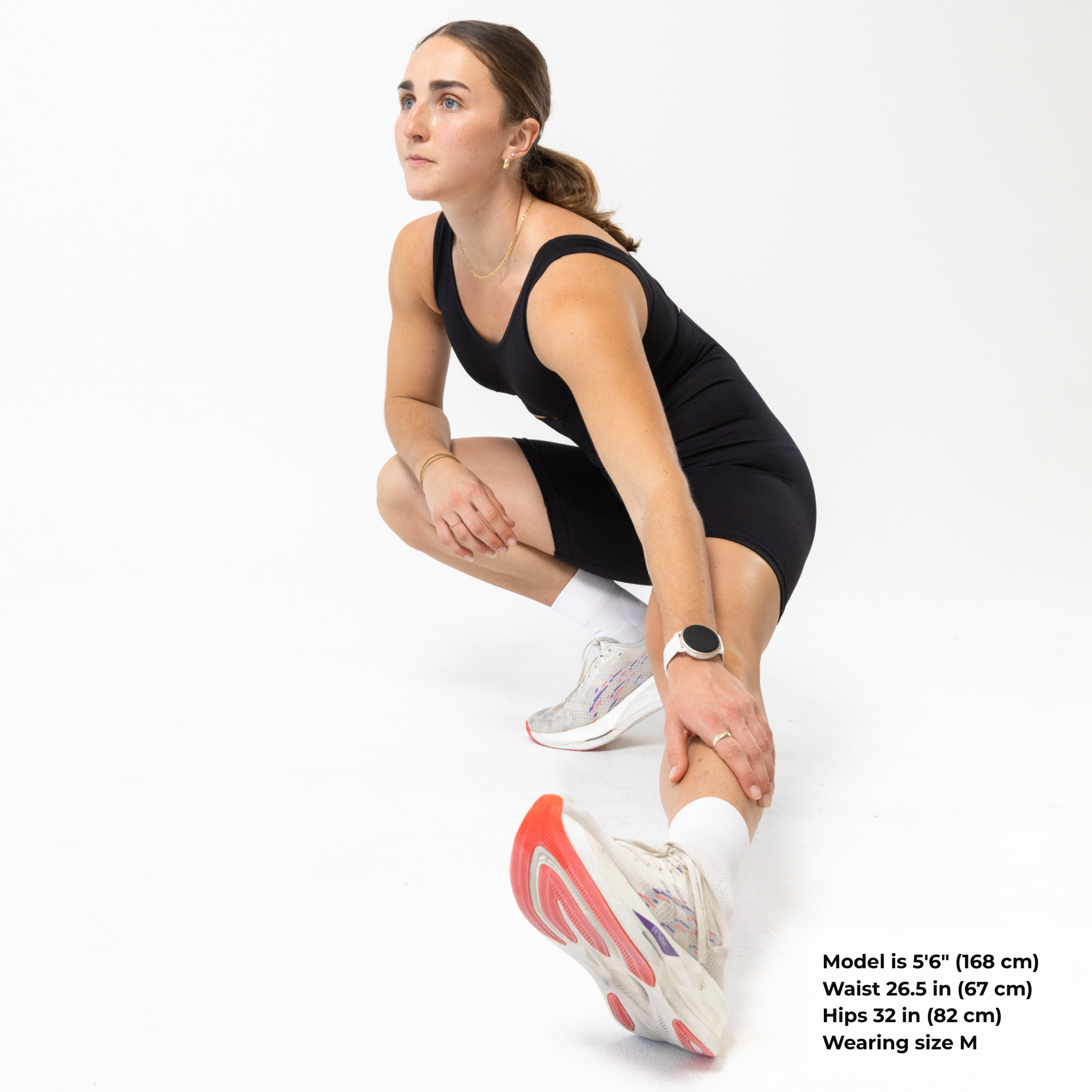 Woman exercising in black KORFORM™ high-waisted compression shorts