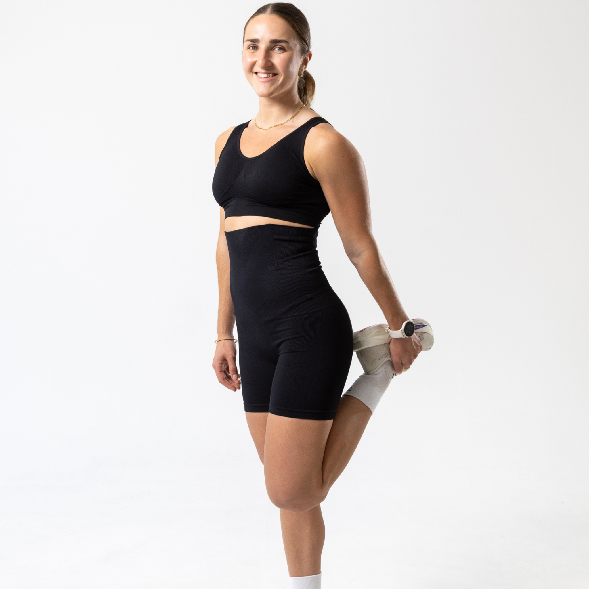 Woman wearing black KORFORM™ high-waisted compression shorts front view