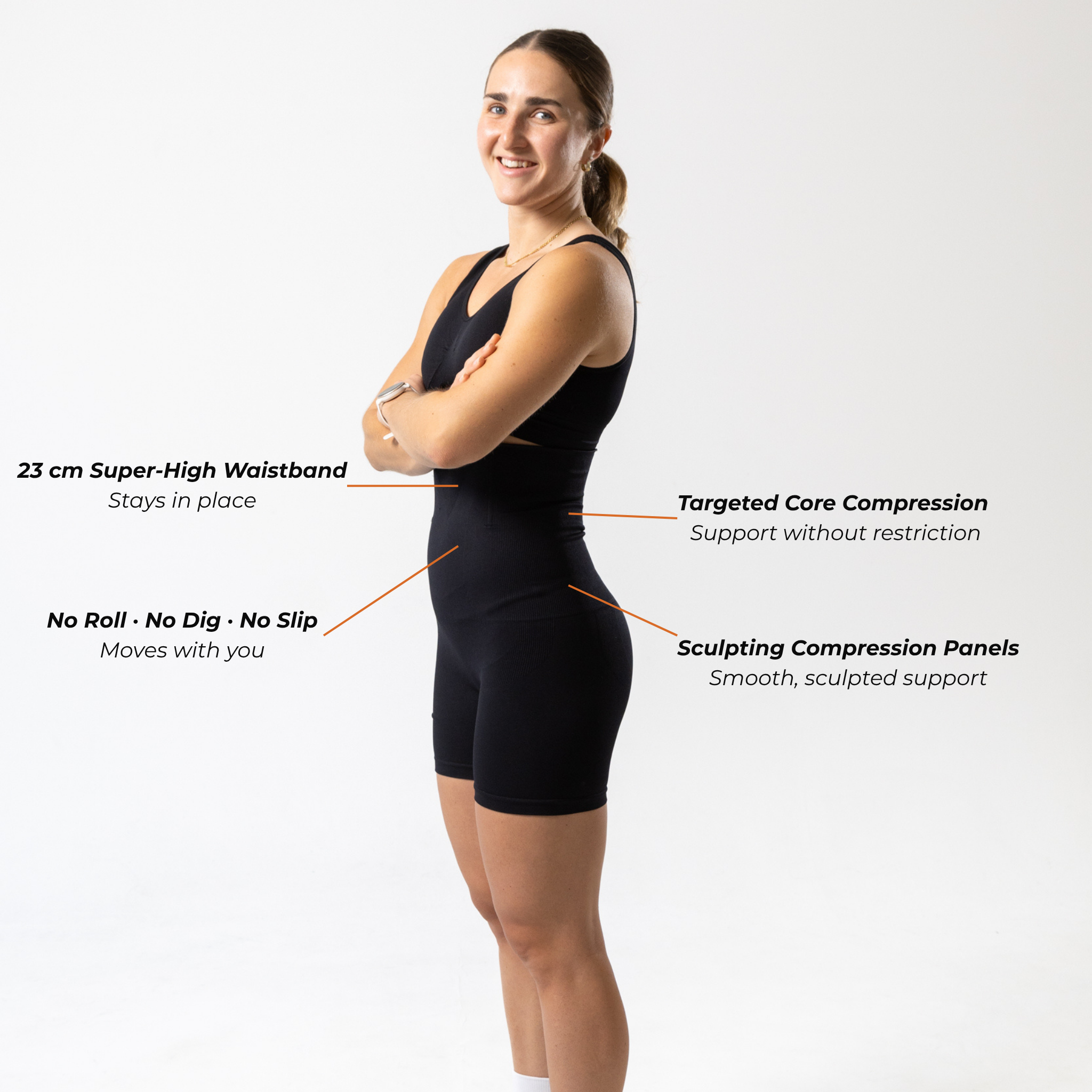 Side view of woman wearing black KORFORM™ high-waisted compression shorts with compression technology highlights