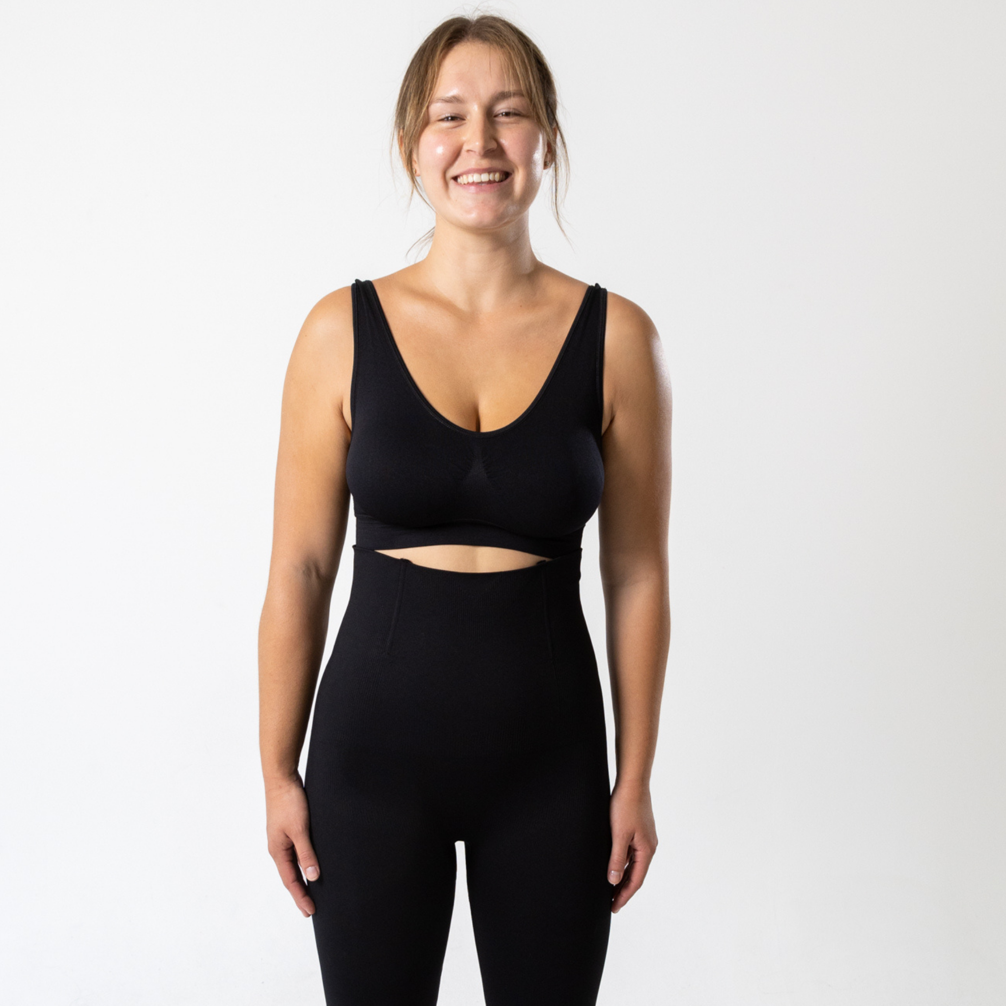 Woman wearing black KORFORM™ sports bra front view