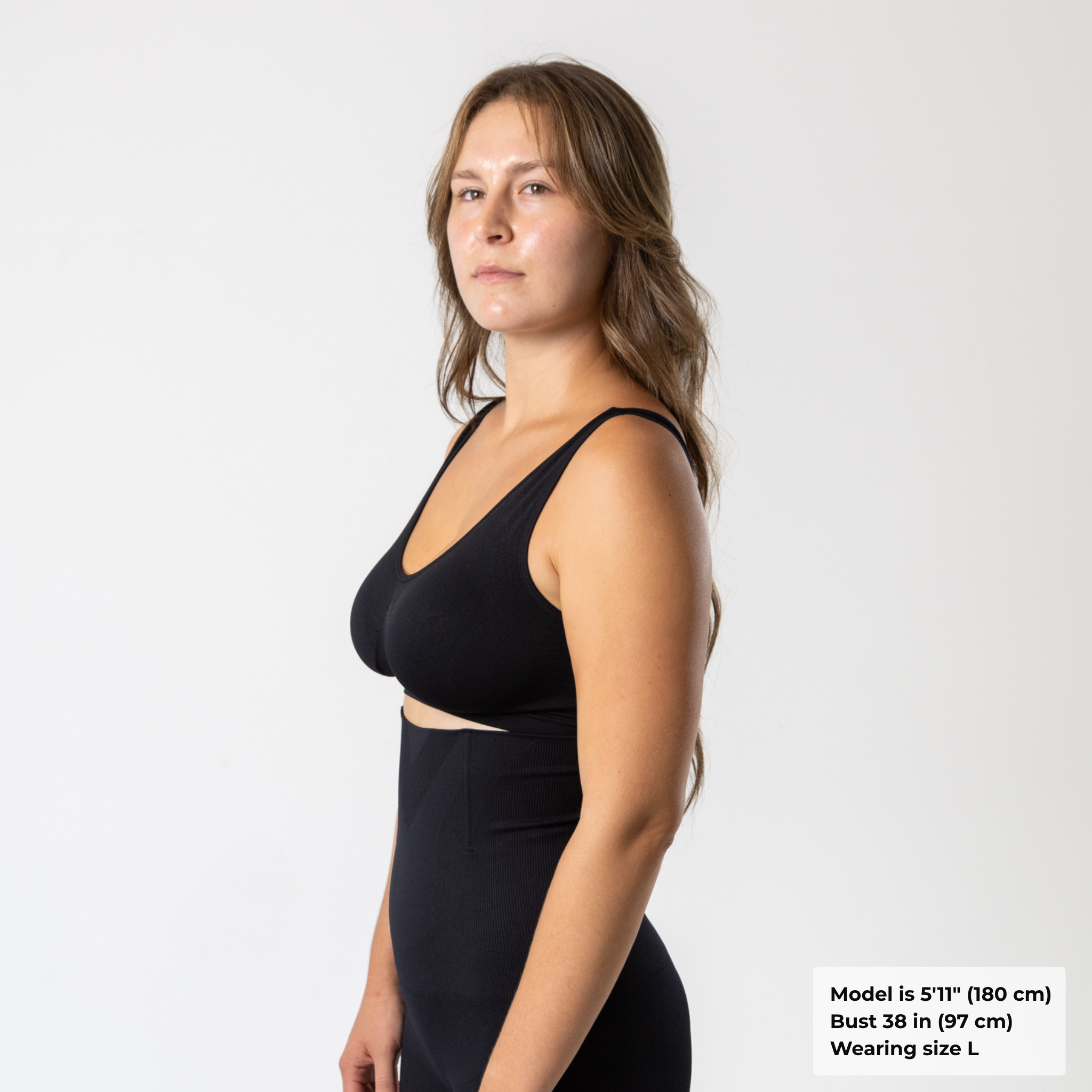 Side view of woman wearing black KORFORM™ sports bra