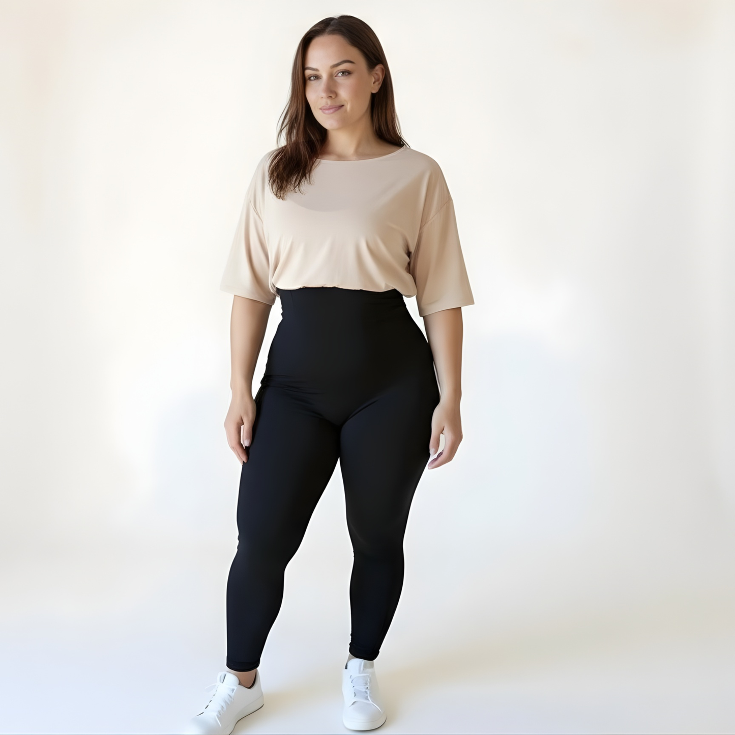 Woman wearing high-waisted black compression leggings and a grey gym t-shirt, showing the natural fit and versatility of KORFORM activewear.